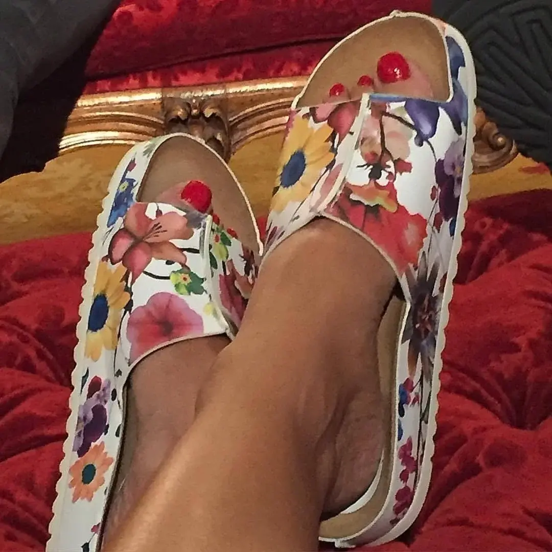 Elizabeth Hurley Sitting woman surrounded by hay.